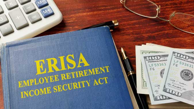 Book on ERISA Claims with money beside it